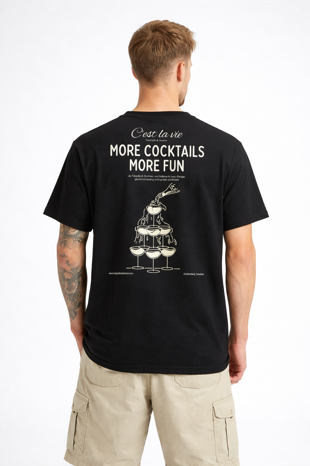 Person wearing a black t-shirt with a graphic and text on the back, standing against a white background.