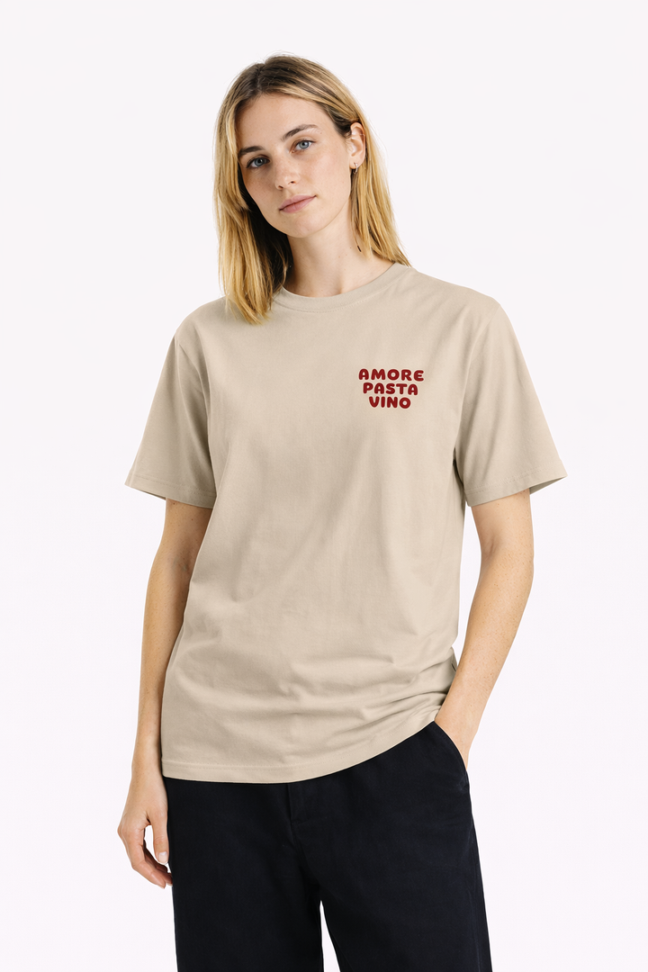 Woman wearing a beige t-shirt with red text on a white background