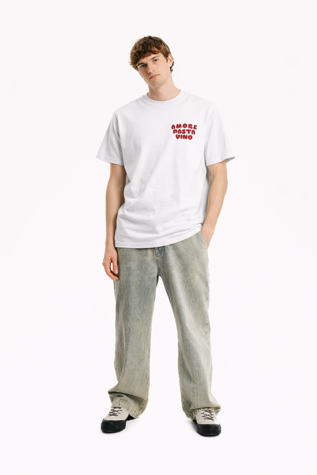 Person wearing a white t-shirt with text and light gray pants on a white background