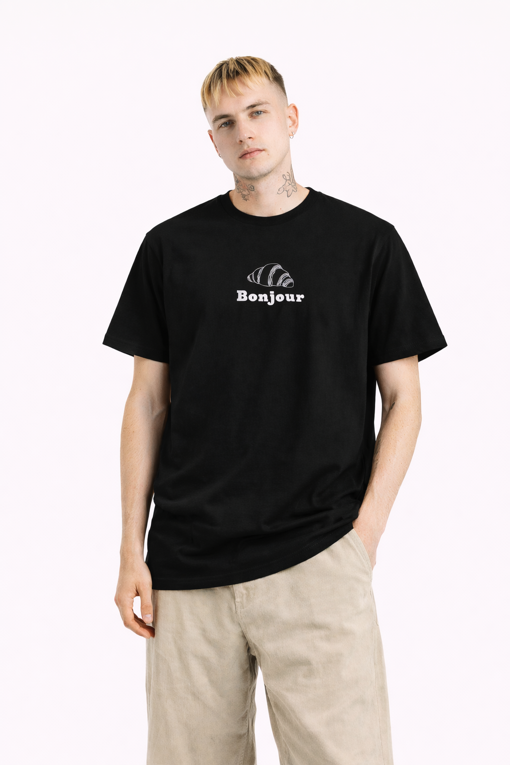 Person wearing a black t-shirt with 'Bonjour' text on a white background