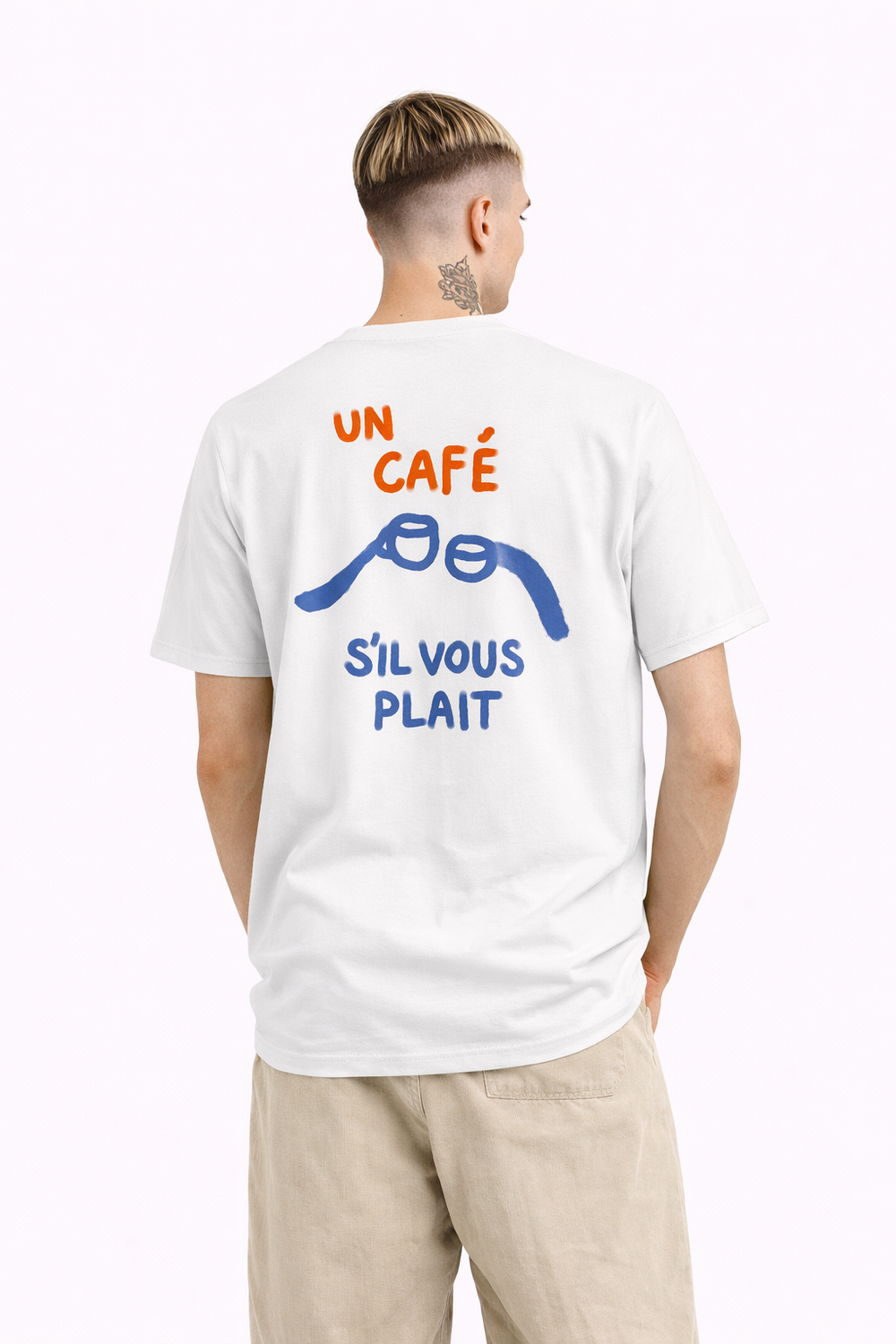 Person wearing a white t-shirt with colorful text and graphics on the back, standing against a white background.