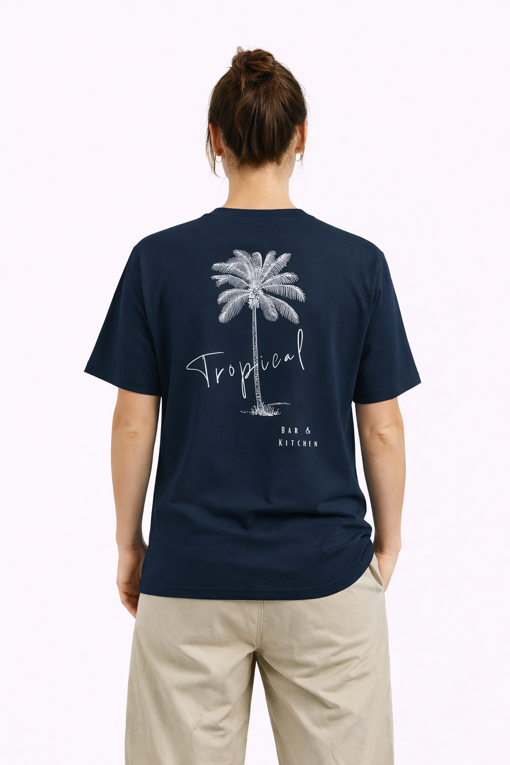 Person wearing a navy blue t-shirt with a palm tree design and 'Tropical' text on the back.