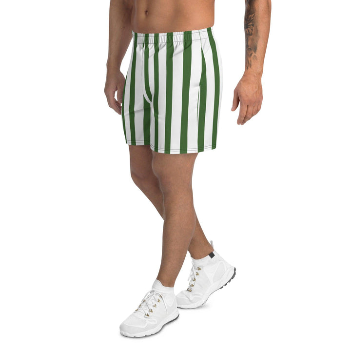 Model wearing men's green athletic shorts, paired with a simple white shoe, highlighting the breathable fabric and relaxed fit.