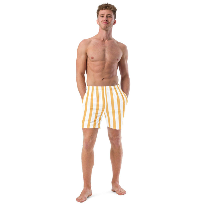 Athletic model wearing yellow and white striped swim trunks, eco-friendly, by Tequila & Sunrise.