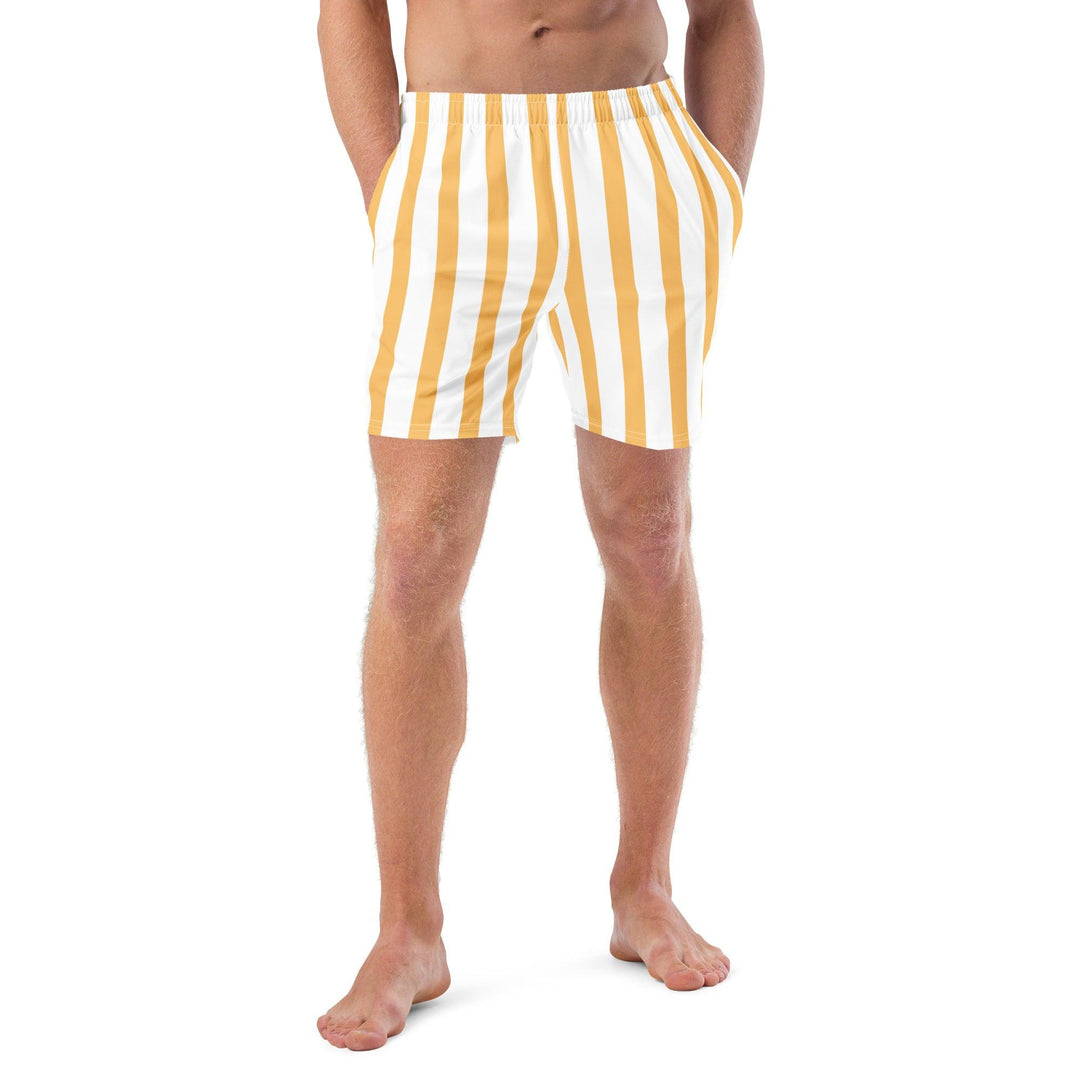 Model wearing yellow and white striped swim trunks, eco-friendly, by Tequila & Sunrise.