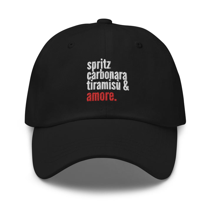 The Love from Italy Hat by Tequila & Sunrise is a black dad hat crafted from chino cotton twill, showcasing white and red text that reads "spritz carbonara tiramisu & amore." It features an adjustable strap for a perfect fit.