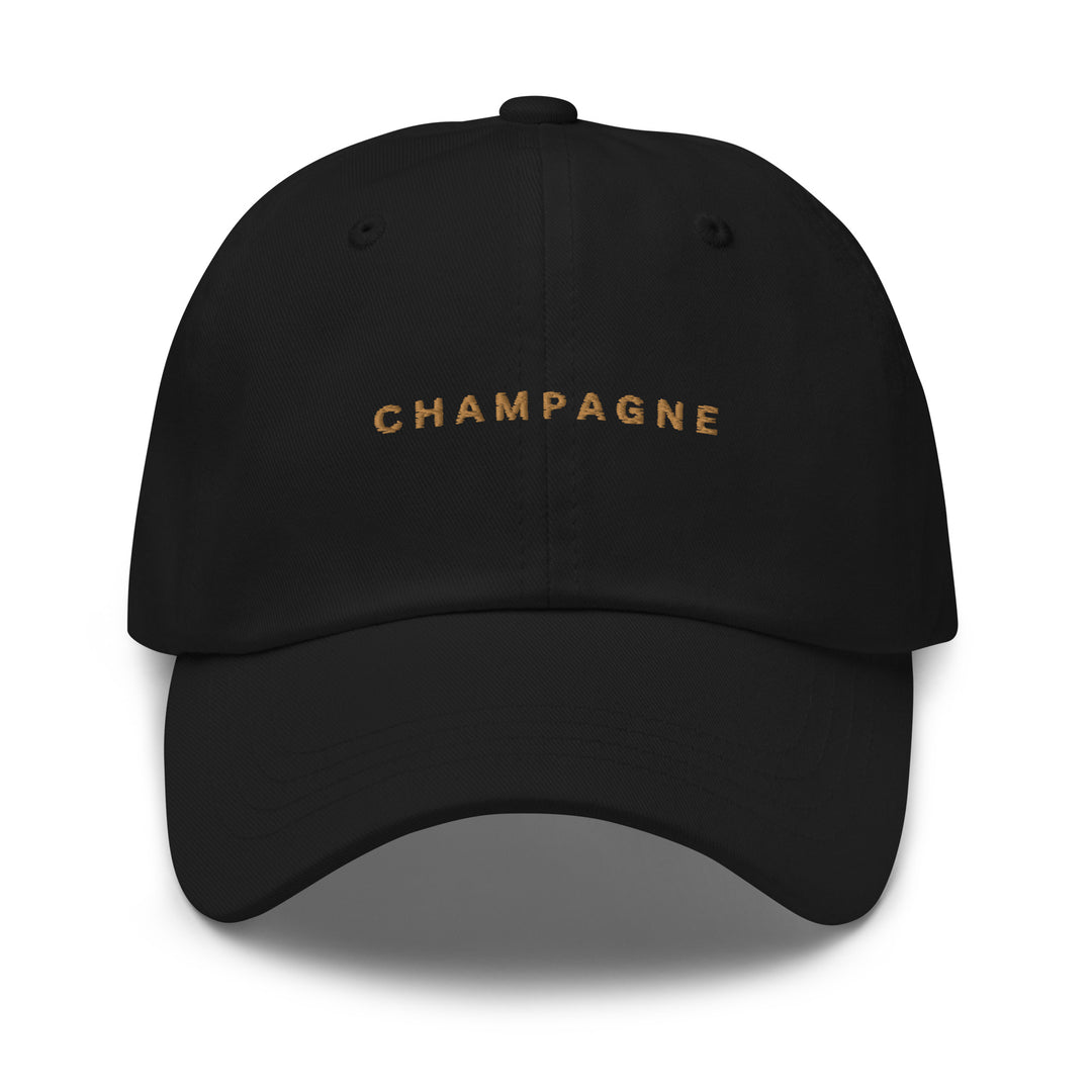 Introducing The Champagne Dad Hat by Tequila & Sunrise: This stylish accessory is crafted from durable chino cotton twill and features the word "CHAMPAGNE" beautifully embroidered in gold on the front. It also includes an adjustable strap to ensure a perfect fit every time.