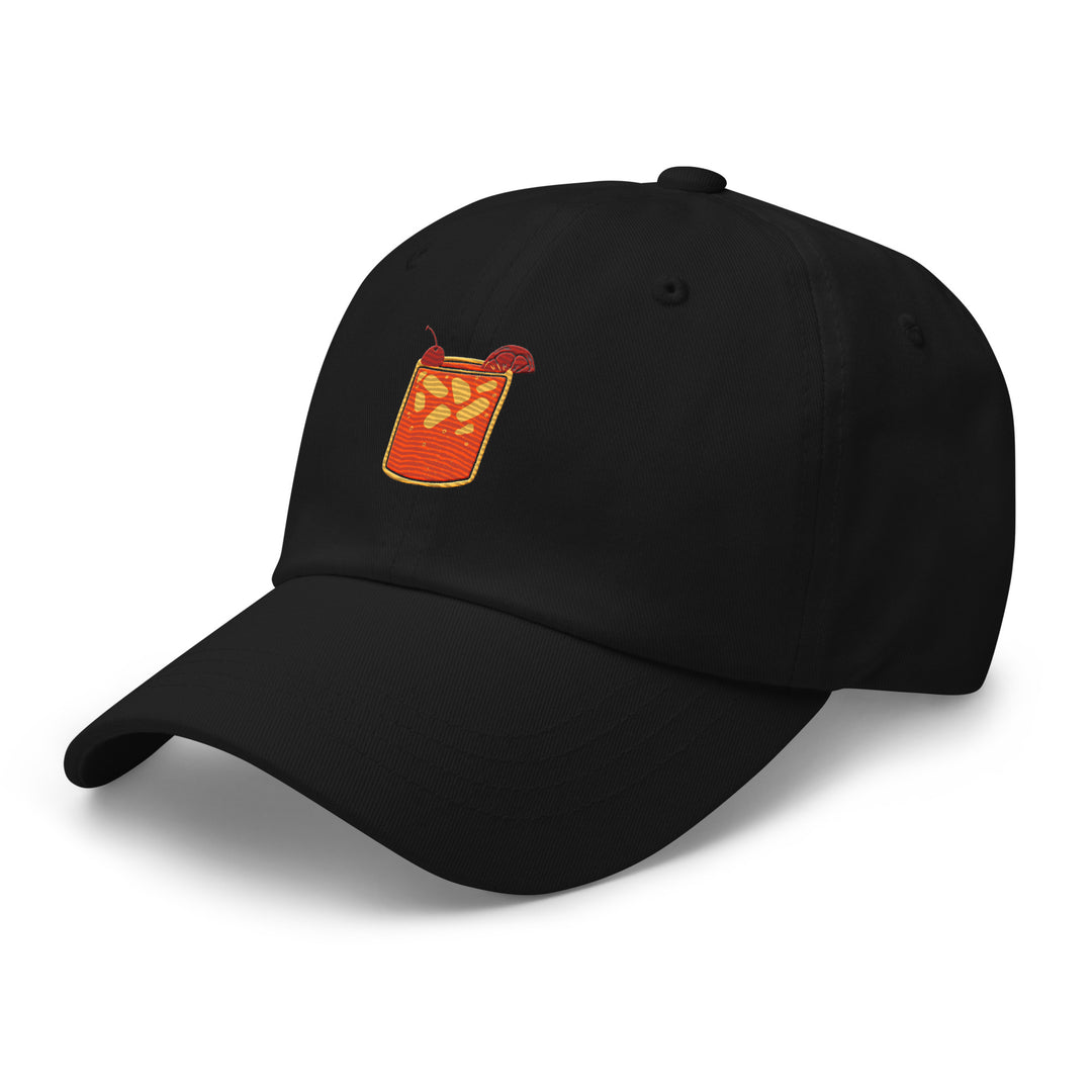 The Tequila & Sunrise Glass Hat, a low-profile black baseball cap by Tequila & Sunrise, showcases an embroidered image of a drink with ice cubes, a straw, and a slice of fruit. This Dad hat features an adjustable strap, seamlessly blending casual style and comfort.