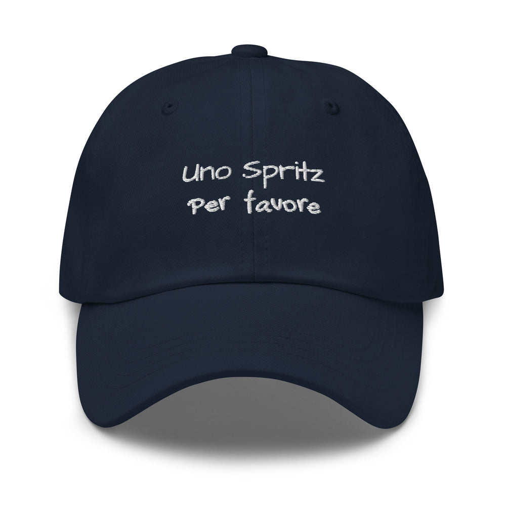 The Uno Spritz Per Favore by Tequila & Sunrise is a blue dad hat crafted from chino cotton twill, showcasing white text that reads "uno spritz per favore." It features an adjustable strap for a perfect fit.