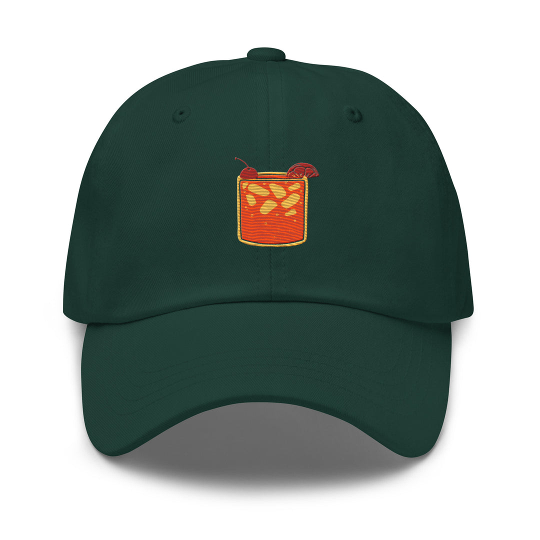 The Tequila & Sunrise Glass Hat by Tequila & Sunrise showcases a dark green Dad hat adorned with an embroidered design of a drink featuring ice cubes and an orange slice. Its low-profile style and adjustable strap promise a comfortable fit for any adventure.