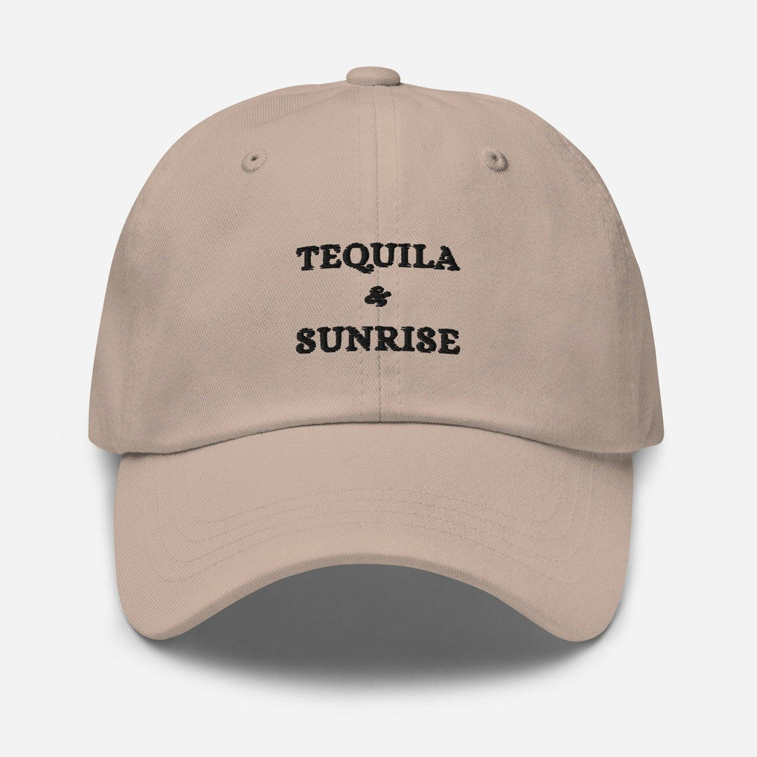 The Tequila & Sunrise Hat by Tequila & Sunrise is a beige dad hat with the Tequila & Sunrise logo expertly embroidered in black on the front, featuring an adjustable strap for a perfect fit.