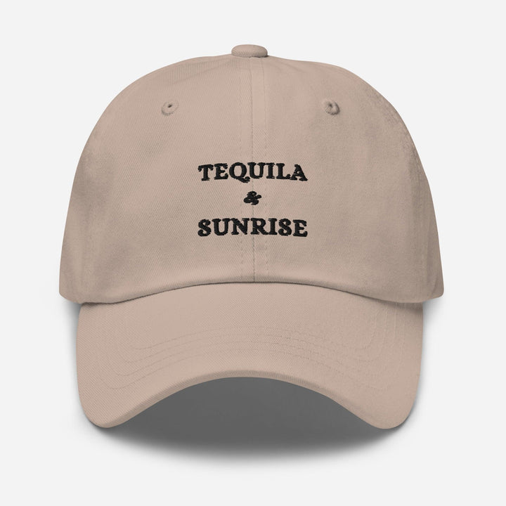 The Tequila & Sunrise Hat by Tequila & Sunrise is a beige dad hat with the Tequila & Sunrise logo expertly embroidered in black on the front, featuring an adjustable strap for a perfect fit.