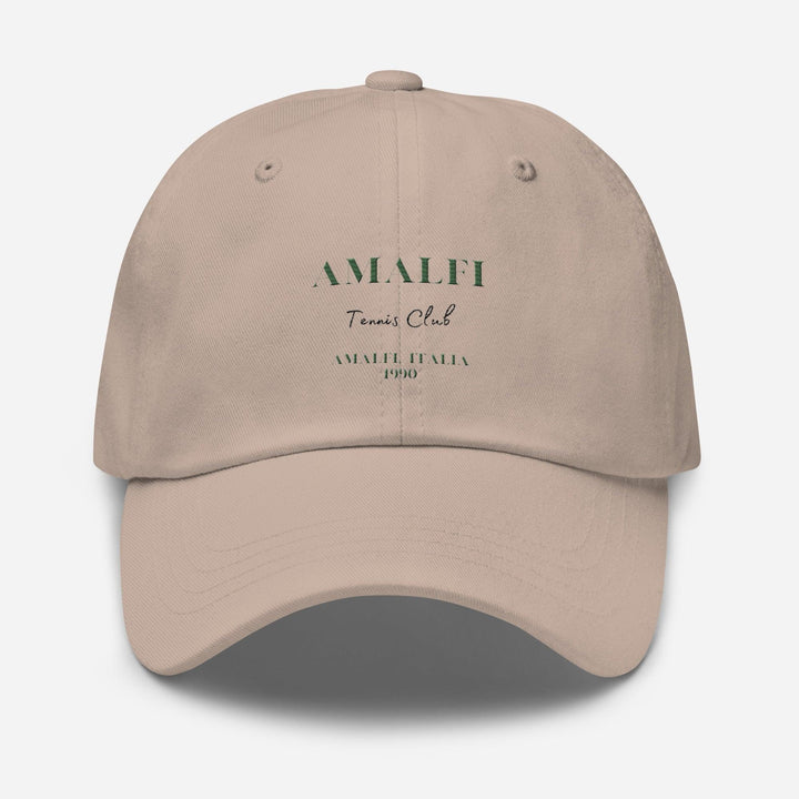 Introducing the Amalfi Tennis Club Italia Hat by Tequila & Sunrise: A beige baseball cap made from chino cotton twill, showcasing "Amalfi Tennis Club" and "Amalfi, Italia 1990" in green on the front. This classic Dad hat includes an adjustable strap for a perfect fit.