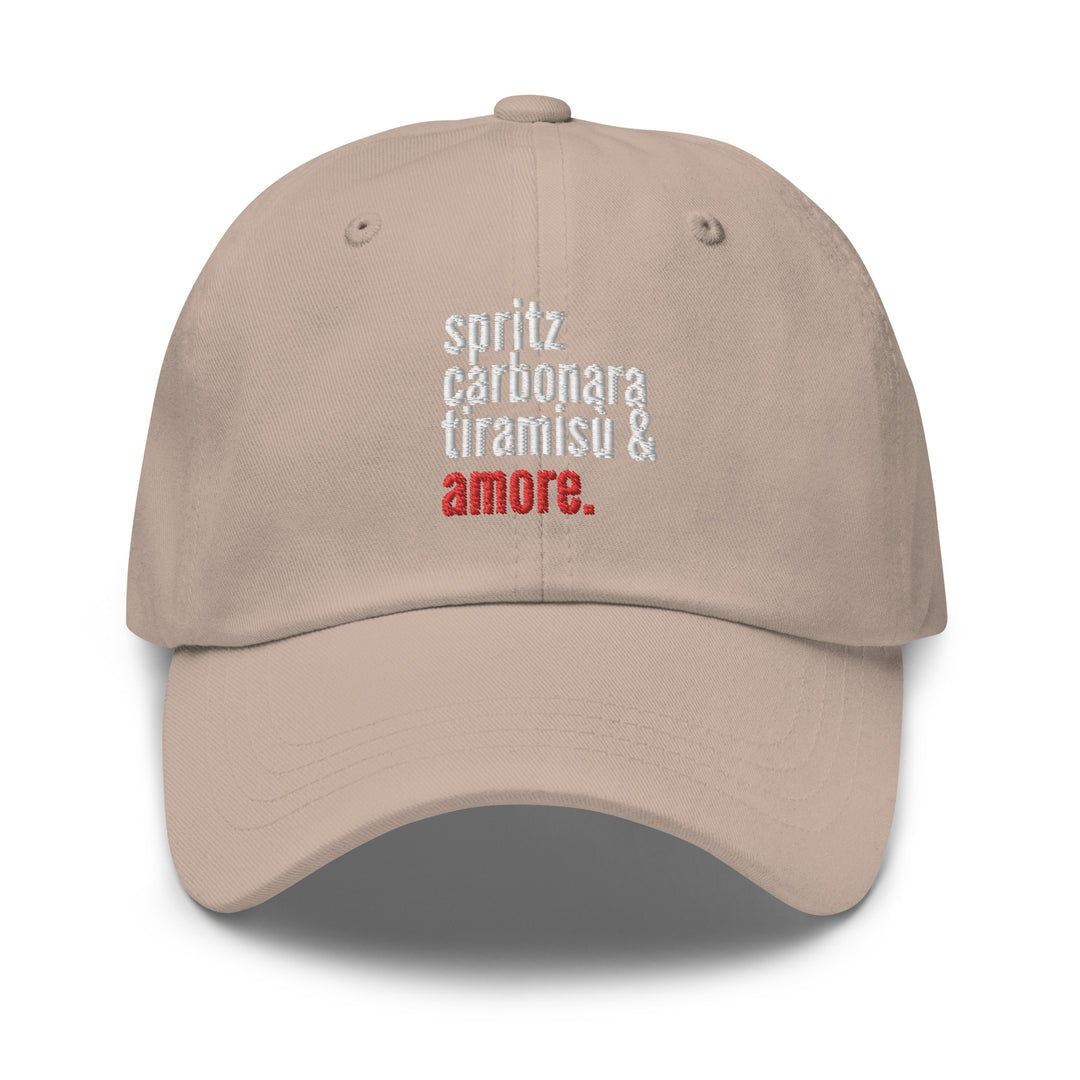 Introducing the Love from Italy Hat by Tequila & Sunrise: This beige baseball cap showcases the embroidered text "spritz carbonara tiramisu & amore" in white and red. Crafted from chino cotton twill, this dad hat is ideal for casual outings and includes an adjustable strap for a comfortable fit.