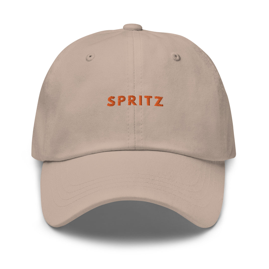 Introducing The Spritz Dad Hat by Tequila & Sunrise: This beige hat showcases a low-profile design and features "SPRITZ" embroidered in vibrant orange on the front, complete with an adjustable strap for the perfect fit.