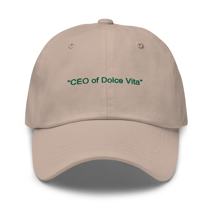 The CEO of Dolce Vita Hat from Tequila & Sunrise is a beige Dad hat adorned with green text and boasts a low-profile design along with an adjustable strap for the perfect fit.