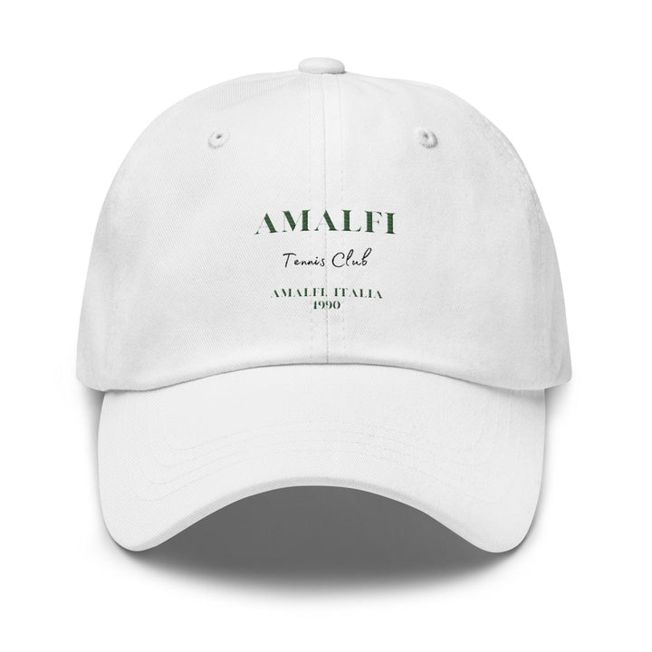 The Amalfi Tennis Club Italia Hat by Tequila & Sunrise is a white baseball cap made from chino cotton twill, adorned with "Amalfi Tennis Club" and "Amalfi Italia 1990" printed in green text. This classic Dad hat includes an adjustable strap to ensure a perfect fit.