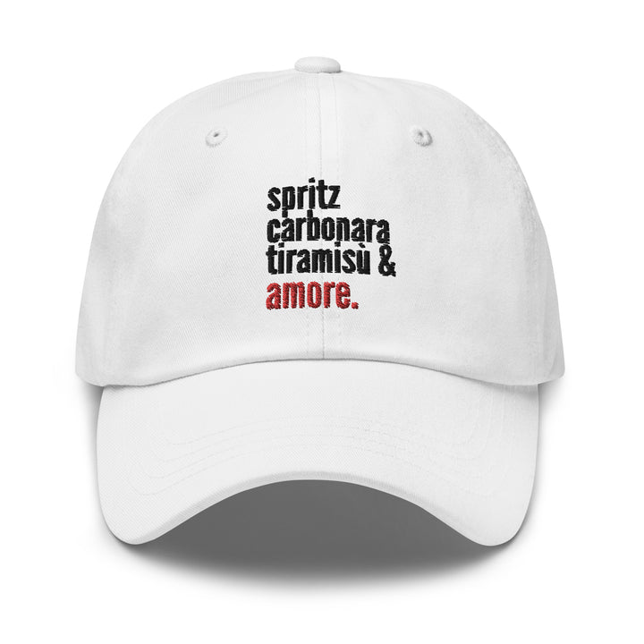 The Love from Italy Hat by Tequila & Sunrise is a white baseball cap made from chino cotton twill, featuring the text "spritz carbonara tiramisu & amore." in black and red lettering. This classic dad hat comes with an adjustable strap for a perfect blend of style and comfort.