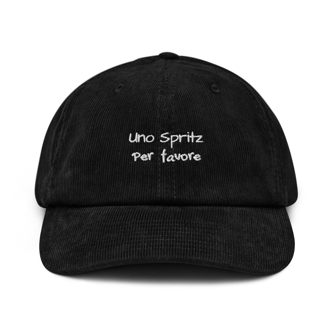 The Uno Spritz Per Favore Corduroy hat by Tequila & Sunrise is a black cotton corduroy baseball cap featuring the phrase "Uno Spritz Per favore" embroidered in white on the front. It includes an adjustable buckle for a perfect fit.