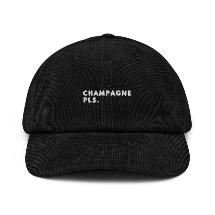 The Champagne Please Corduroy Hat by Tequila & Sunrise is a black corduroy hat with white embroidered text that reads "CHAMPAGNE PLS" and includes an adjustable buckle for a perfect fit.