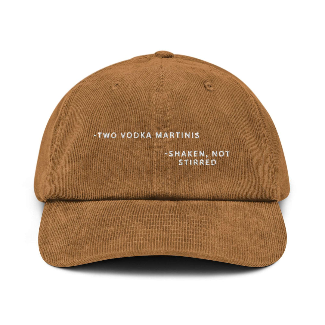 Brown cotton corduroy cap from Tequila & Sunrise, known as "The Shaken, not Stirred James Bond Quote Corduroy Hat," featuring an adjustable buckle and white embroidered text: -Two Vodka Martinis - Shaken, Not Stirred.