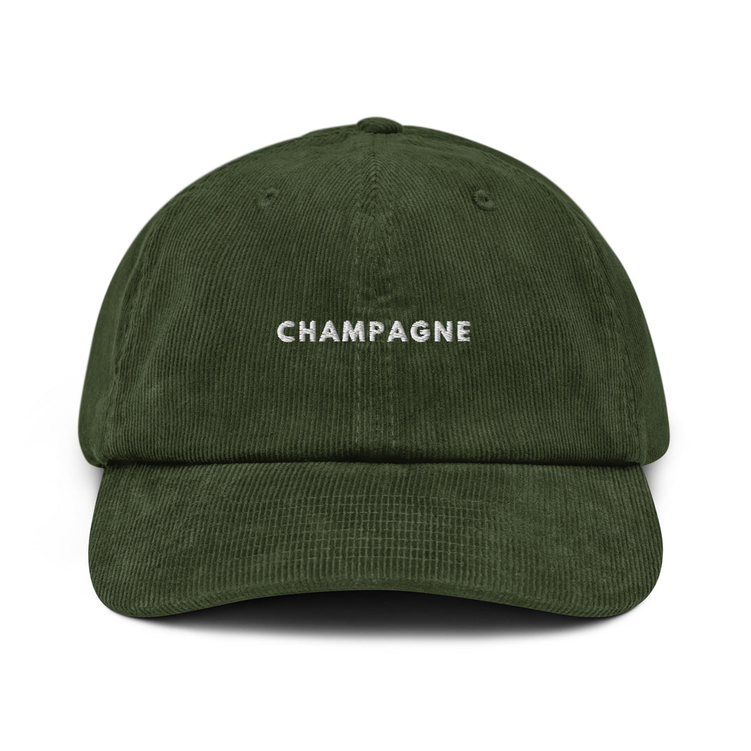 Introducing the Champagne Corduroy hat by Tequila & Sunrise: a dark green cotton corduroy baseball cap with an adjustable buckle, featuring "Champagne" elegantly embroidered in white on the front.