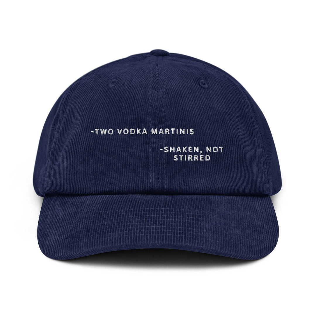 Here's a suggestion for the rewritten sentence:

The Tequila & Sunrise "The Shaken, not Stirred James Bond Quote Corduroy Hat" is a navy blue cap featuring the iconic phrase embroidered in white and an adjustable buckle for a perfect fit.