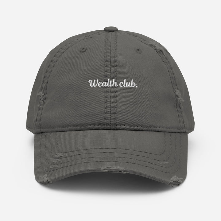 Introducing The Wealth Club Hat by Tequila & Sunrise, a stylish charcoal grey distressed dad hat featuring the word Wealth Club. elegantly embroidered in white on the front. This cap includes subtle distressing on the brim and panels, making it a chic addition to any sophisticated wardrobe.