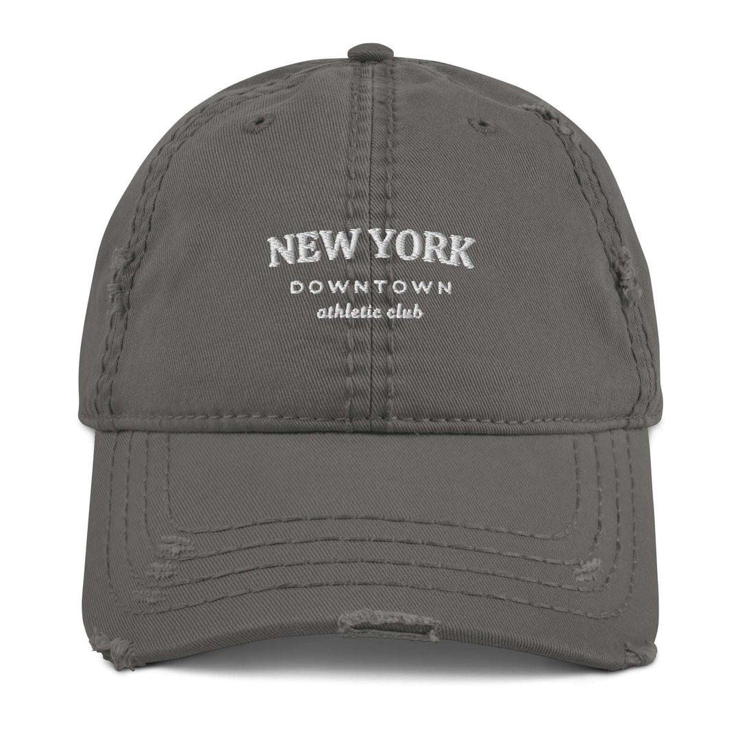 The New York Downtown Athletic Club Hat by Tequila & Sunrise is a gray dad hat with white embroidered text. Made from pre-shrunk cotton twill, it boasts a distressed brim that enhances its character and charm.