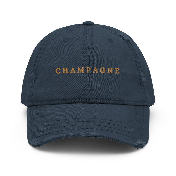 Introducing The Champagne Hat by Tequila & Sunrise, a stylish black dad hat featuring the word CHAMPAGNE elegantly embroidered in yellow on the front. This cap includes subtle distressing on the brim and panels, making it a chic addition to any sophisticated wardrobe.