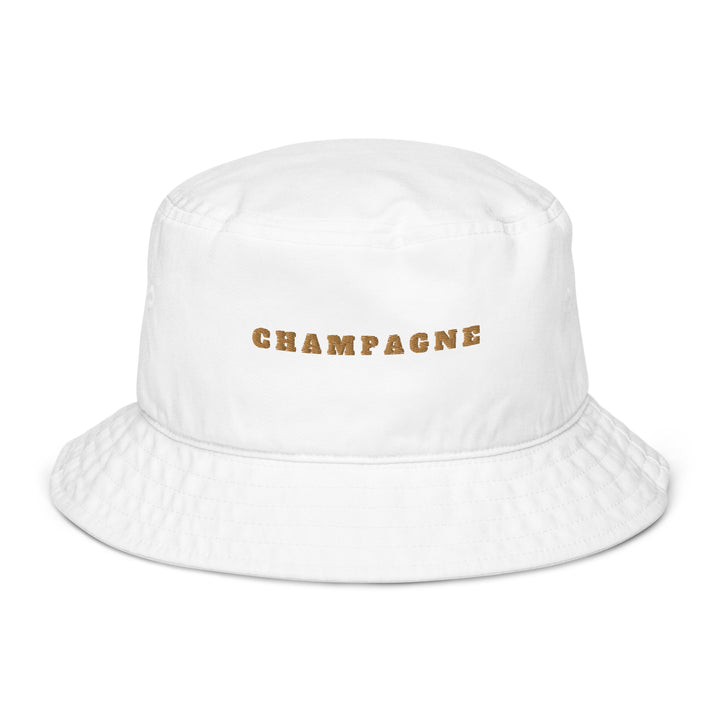 Introducing The Champagne Organic Bucket Hat by Tequila & Sunrise: a white, eco-friendly bucket hat crafted from 100% organic cotton with the word CHAMPAGNE elegantly printed in gold lettering on the front.