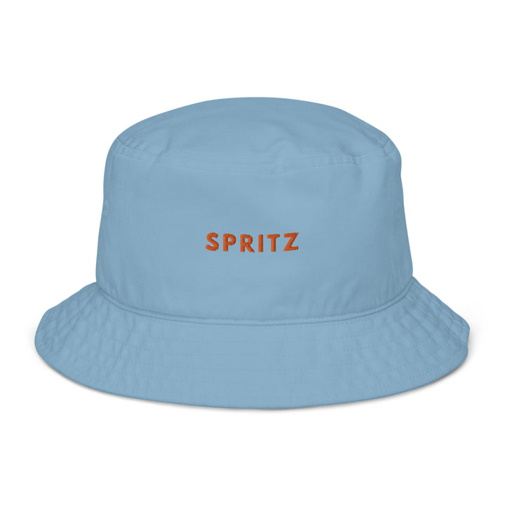 The Spritz Organic Bucket Hat by Tequila & Sunrise is a light blue, eco-friendly fashion statement crafted from 100% cotton, featuring the word SPRITZ embroidered in orange on the front.