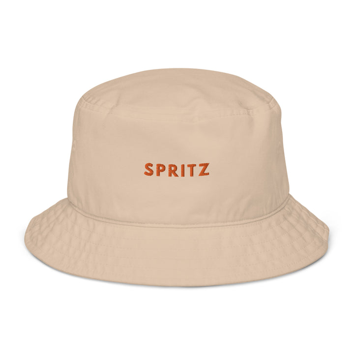 The Tequila & Sunrise Spritz Organic Bucket Hat is an eco-friendly beige accessory crafted from 100% organic cotton, with the SPRITZ text beautifully embroidered in vibrant orange on the front.