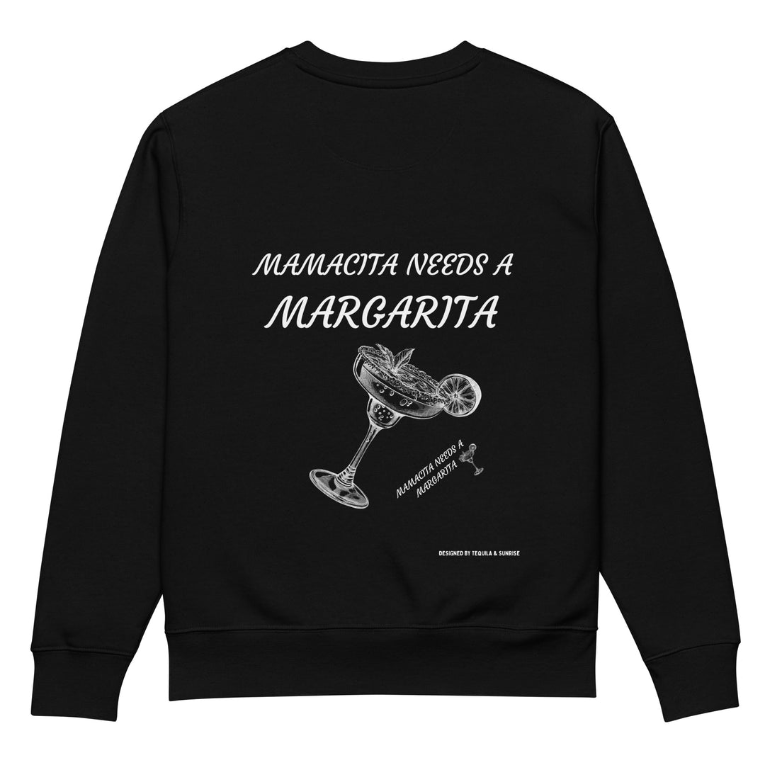 Explore The Mamacita Needs a Margarita Eco Sweatshirt by Tequila & Sunrise. Made from organic cotton, this unisex black sweatshirt showcases the bold white text "Mamacita Needs a Margarita" alongside an illustration of a spilled margarita glass with a lime. Enjoy sustainable fashion with a touch of playful charm.