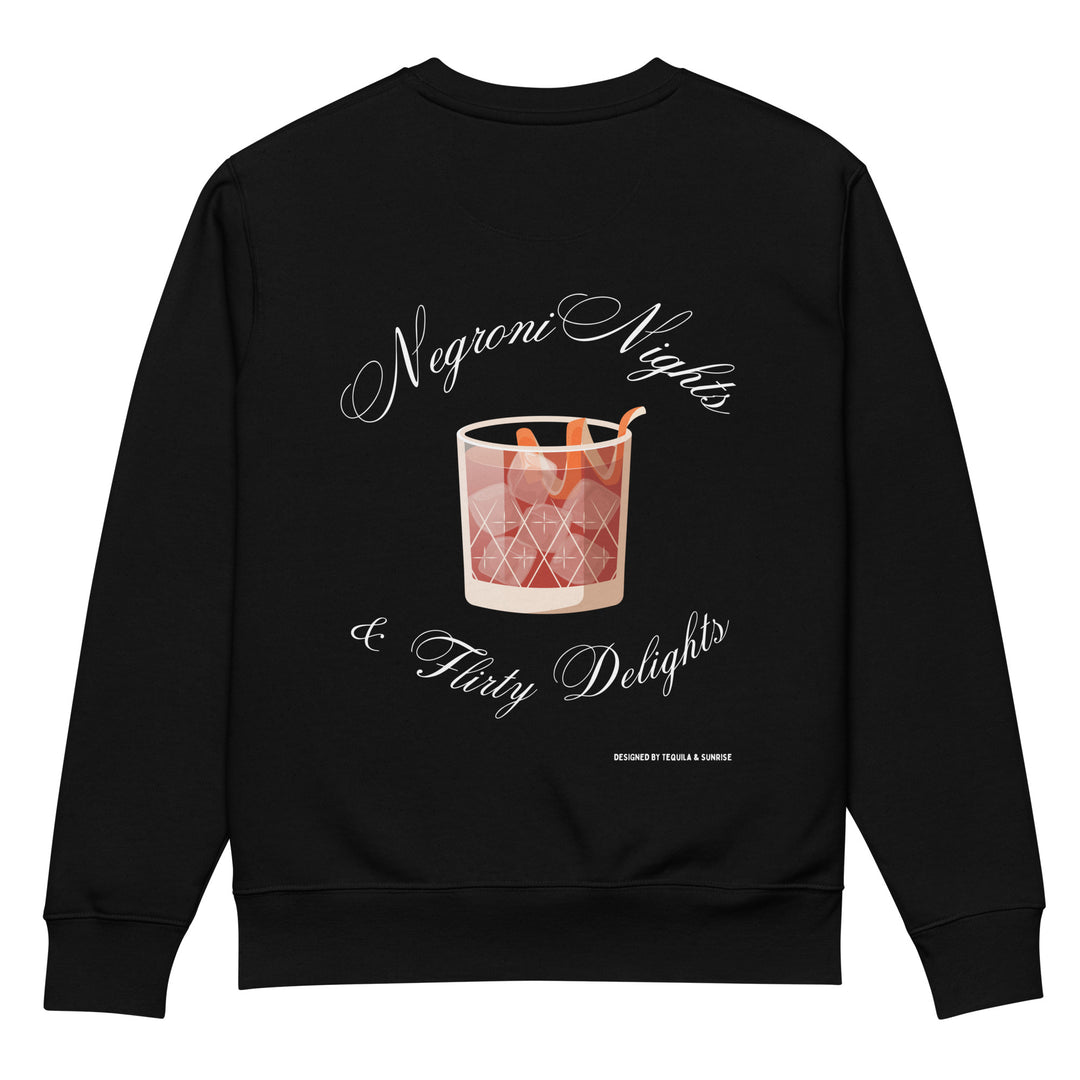 Introducing the Negroni Nights & Flirty Delights Eco Sweatshirt from Tequila & Sunrise. This black unisex sweatshirt boasts an illustration of a Negroni cocktail in a glass adorned with an orange peel garnish, encircled by the text "Negroni Nights & Flirty Delights." Designed by Tarina A Sinner, it's made from organic cotton to support sustainable fashion.