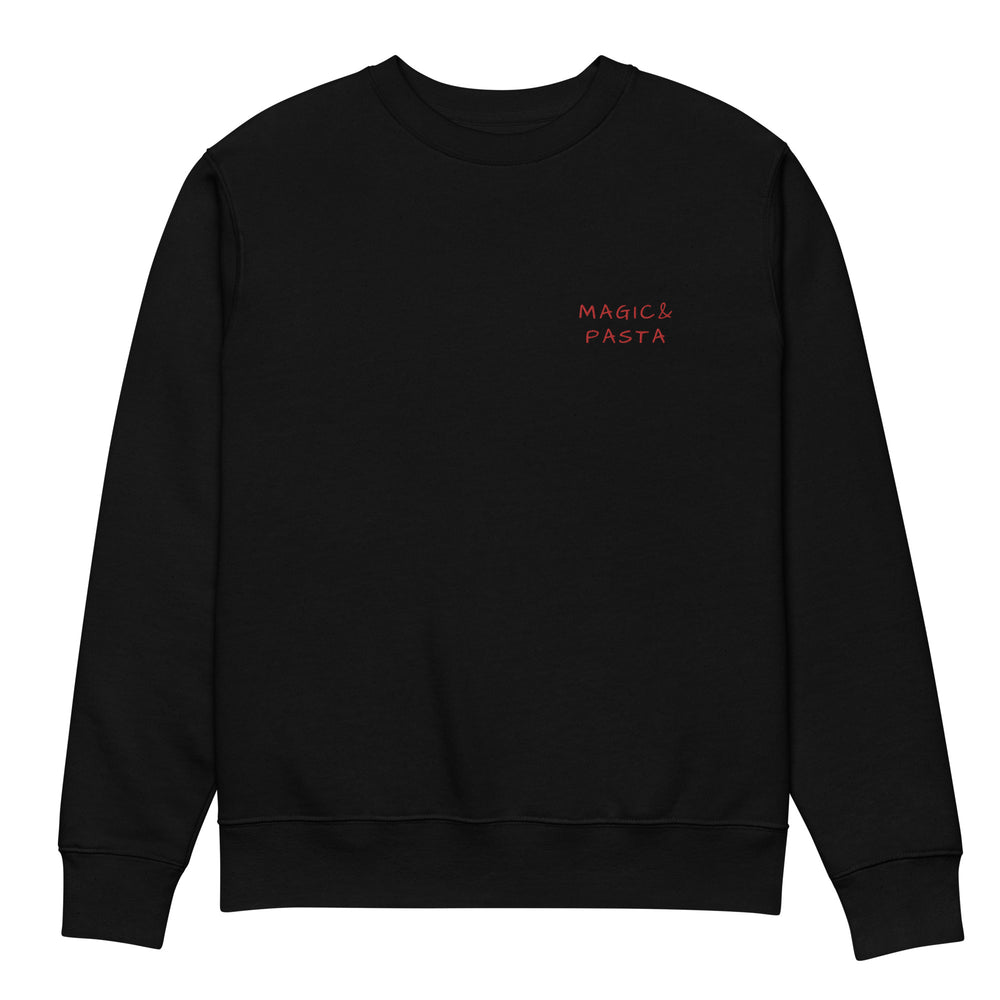 Introducing "The Magic & Pasta Eco Sweatshirt" by Tequila & Sunrise: This black unisex sweatshirt features the words "Magic & Pasta" elegantly embroidered in red on the left chest area. Crafted from organic cotton, it offers a simple and minimalistic design with a crew neck and long sleeves, perfectly merging sustainable fashion with style.