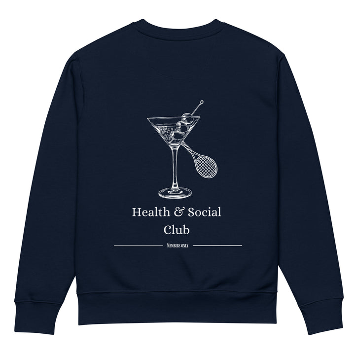 The Health & Social Club Eco Sweatshirt by Tequila & Sunrise is a durable and comfy navy blue organic cotton sweatshirt. It features a graphic of a cocktail glass and a badminton racket intersecting, with the text "Health & Social Club" at the top and "Members Only" below. Made on demand to ensure top quality.