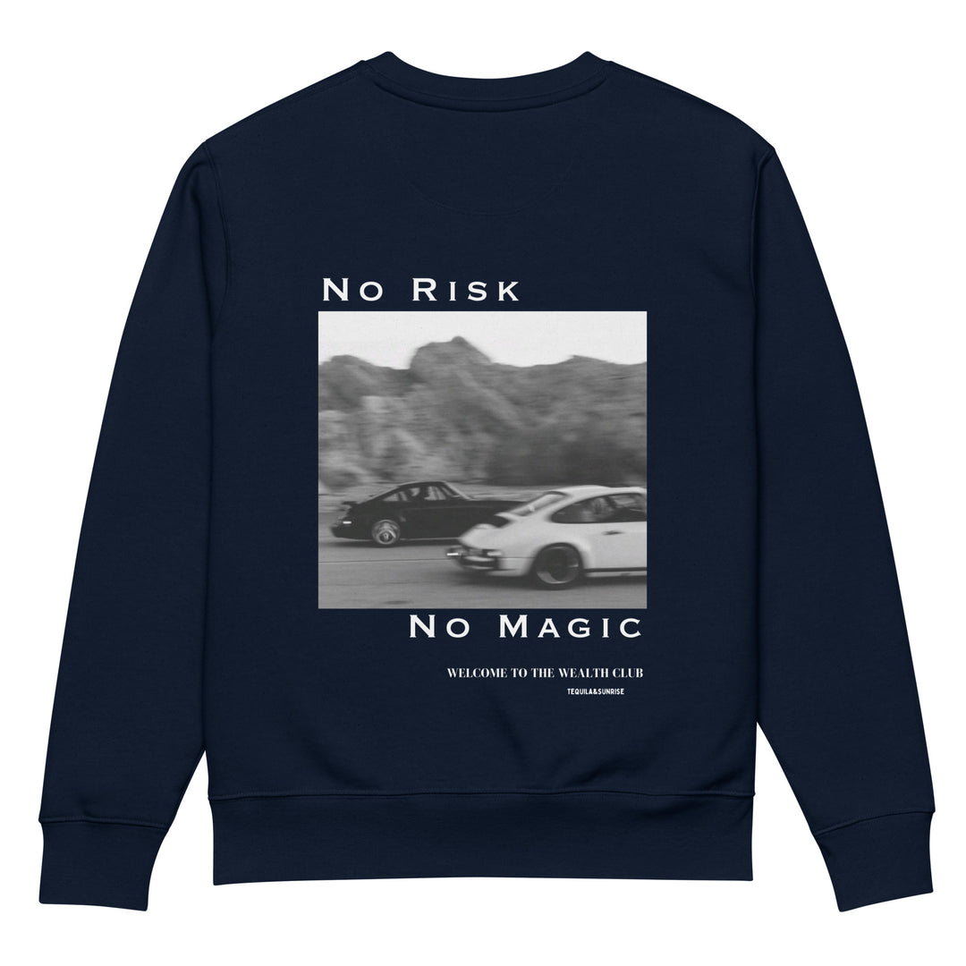 The No Risk No Magic Eco Sweatshirt by Tequila & Sunrise is a navy blue unisex piece made from organic cotton, featuring a graphic of two cars driving through a desert landscape with the words "No Risk No Magic" and "Welcome to the Wealth Club" printed below.