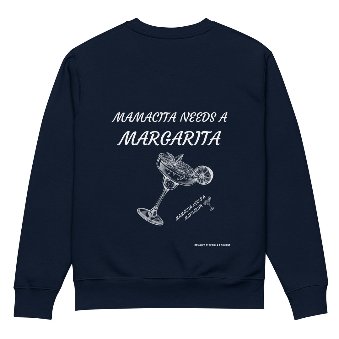 The Mamacita Needs a Margarita Eco Sweatshirt by Tequila & Sunrise is crafted from organic cotton in navy blue, adorned with playful white text reading "Mamacita Needs a Margarita" above an illustration of a tilted margarita glass with a wedge of lime. This unisex, eco-friendly piece is ideal for embracing sustainable fashion on casual, fun-filled days.