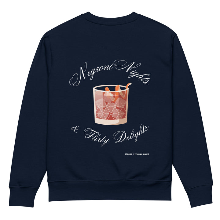 The Negroni Nights & Flirty Delights Eco Sweatshirt by Tequila & Sunrise is a navy unisex garment made from organic cotton. It showcases a graphic of a Negroni cocktail with an orange twist, surrounded by the text "Negroni Nights & Flirty Delights" in a cursive font, perfectly blending style with sustainability.