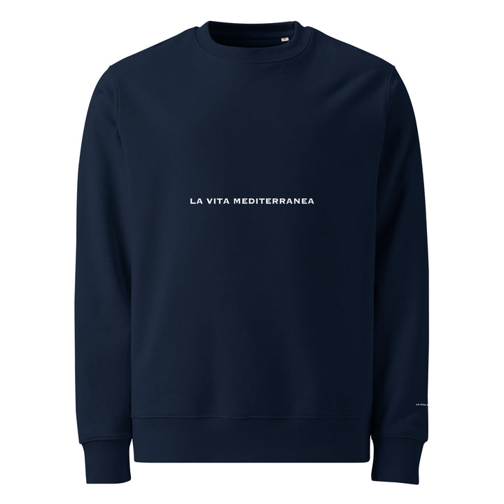 Introducing The La Vita Mediterranea Eco Sweatshirt by Tequila & Sunrise—a navy blue sweatshirt expertly crafted from organic cotton, showcasing the phrase "La Vita Mediterranea" in white, elegantly centered on the front. It's an ideal tribute to the Mediterranean lifestyle.