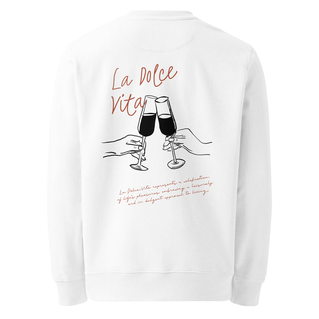 The La Dolce Vita Eco Sweatshirt by Tequila & Sunrise showcases "La Dolce Vita" embroidered in red at the top, accompanied by an illustration of two hands clinking champagne glasses and cursive text beneath. Crafted on demand, it adds a personal touch of elegance with its organic cotton material.