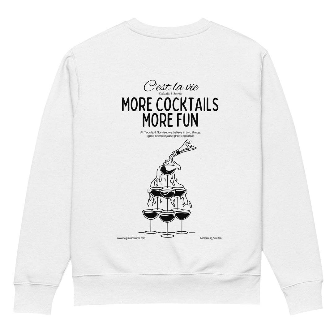 Back of The More Cocktails More Fun Eco Sweatshirt by Tequila & Sunrise showcases an illustration of a cocktail tower pouring into three glasses. The text reads "C'est la vie, more cocktails, more fun" with a tagline about enjoying good company and great drinks. Made from organic cotton for sustainable fashion lovers. Website link included below.