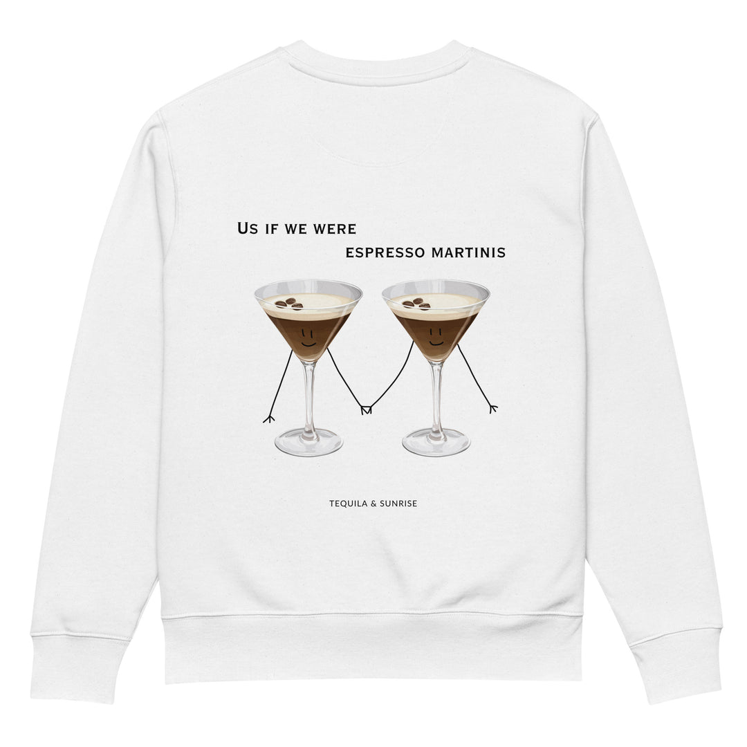 The If We Were Espresso Martinis Eco Sweatshirt by Tequila & Sunrise is made from durable organic cotton and features a playful design of two cartoon espresso martinis holding hands, each with a smiling face and garnished with three coffee beans. The text reads, "Us if we were espresso martinis.