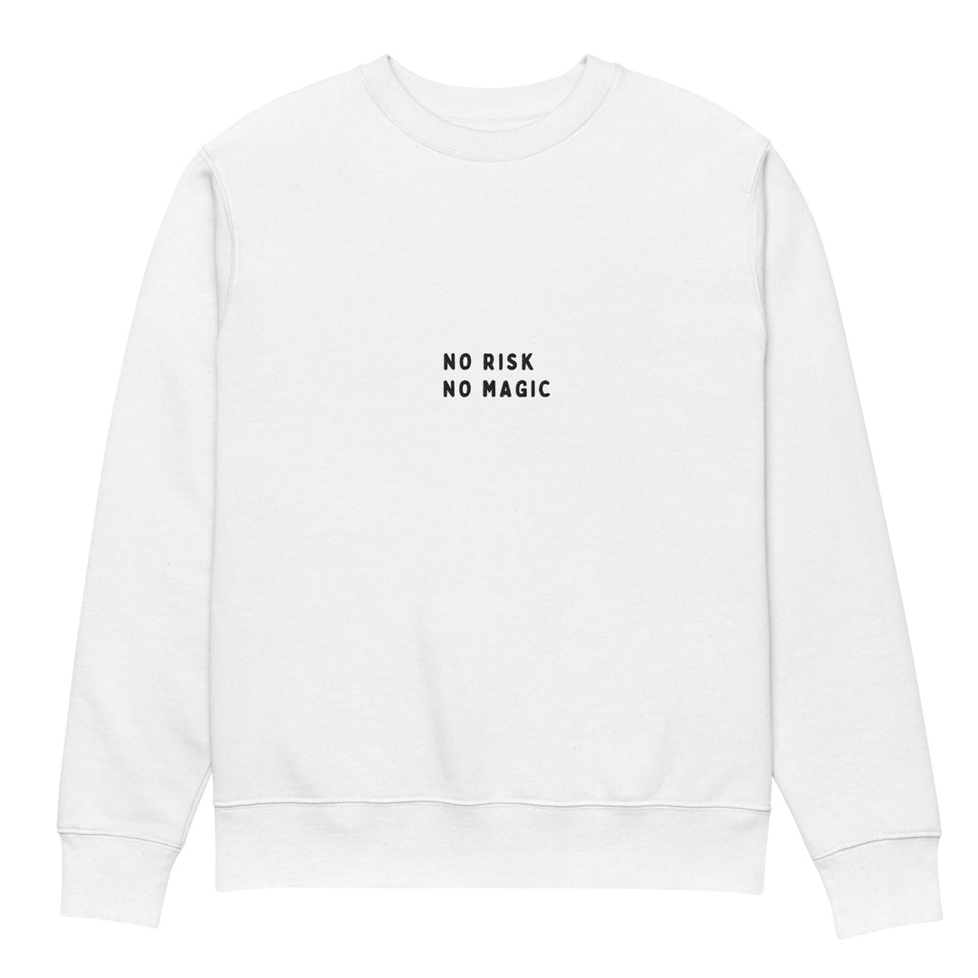 Introducing The No Risk No Magic Eco Sweatshirt by Tequila & Sunrise, a sustainable fashion piece made from organic cotton. This white unisex sweatshirt features the bold phrase "NO RISK NO MAGIC" in striking black capital letters across the front center, offering a simple and minimalistic design.