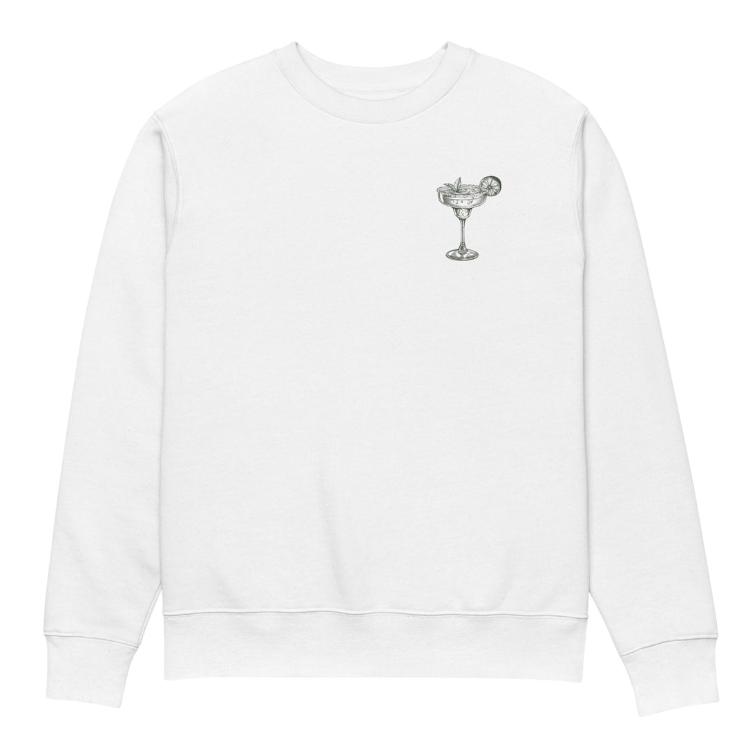 The Mamacita Needs a Margarita Eco Sweatshirt, by Tequila & Sunrise, is a unisex white organic cotton sweatshirt featuring a minimalist embroidered cocktail glass with a lime wedge on the upper left chest. The design promotes sustainable fashion while offering a casual, relaxed fit.