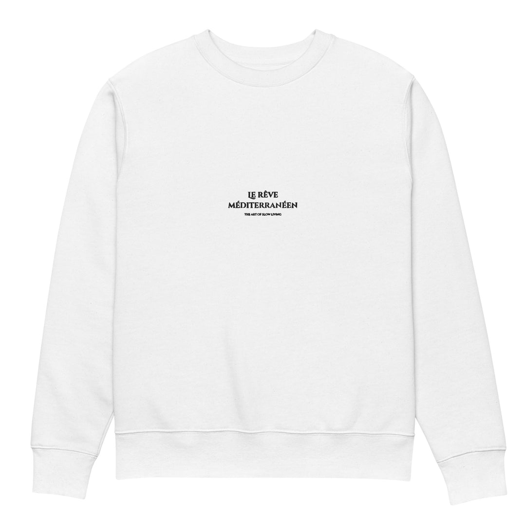 Introducing the Mediterranean Dream Eco Sweatshirt by Tequila & Sunrise: a white sweatshirt made from organic cotton, adorned with the text "Le Rêve Méditerranéen" in black on the chest. Its simple and minimalistic design is ideal for embracing a slow living lifestyle.