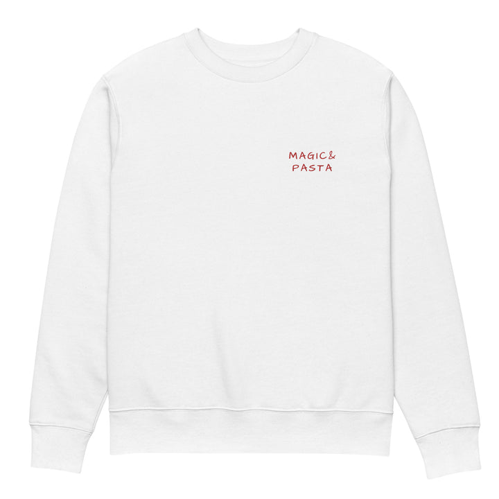 The Magic & Pasta Eco Sweatshirt by Tequila & Sunrise is a white unisex garment made from organic cotton, displaying the words "Magic & Pasta" in small red letters on the left chest. This piece showcases sustainable fashion with its straightforward design and timeless crew neck.