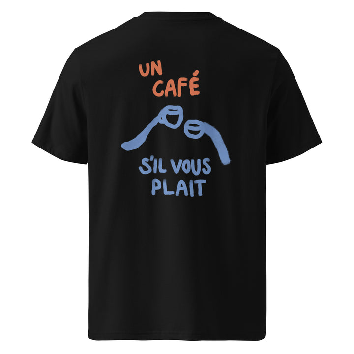 The Tequila & Sunrise brand's "The Un Cafe S'il Vous Plait Organic T-shirt" is a black unisex t-shirt made from eco-friendly organic cotton, displaying the phrase "Un café s'il vous plaît" in vibrant red and blue text, accompanied by a minimalist illustration of two clinking coffee cups.