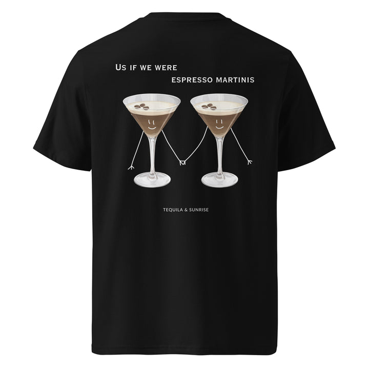 The If We Were Espresso Martinis Organic T-shirt by Tequila & Sunrise is a unisex black T-shirt made from organic cotton. It features an illustration of two espresso martinis holding hands, with the text "Us if we were espresso martinis" and "Tequila & Sunrise." This eco-friendly shirt is stylish for any occasion.